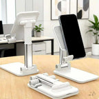 Adjustable Desk Phone Holder in white plastic with silver telescoping supports, folding hinges, and a textured phone rest